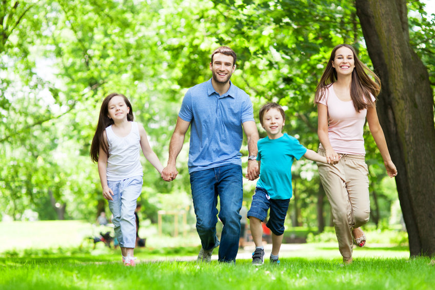 Young Family Having Fun In Park